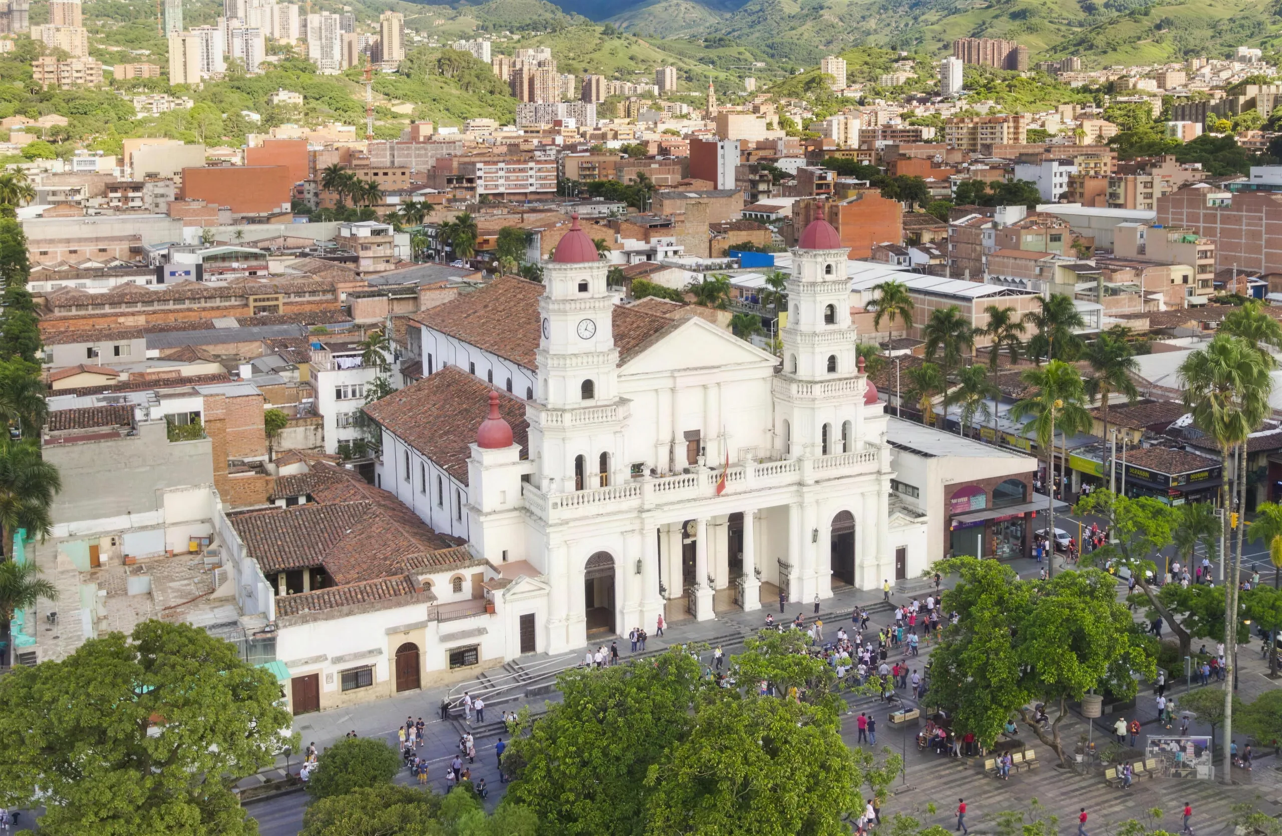 The white cathedral and main plaza of Envigado, the town spread up the green hills of Medellín