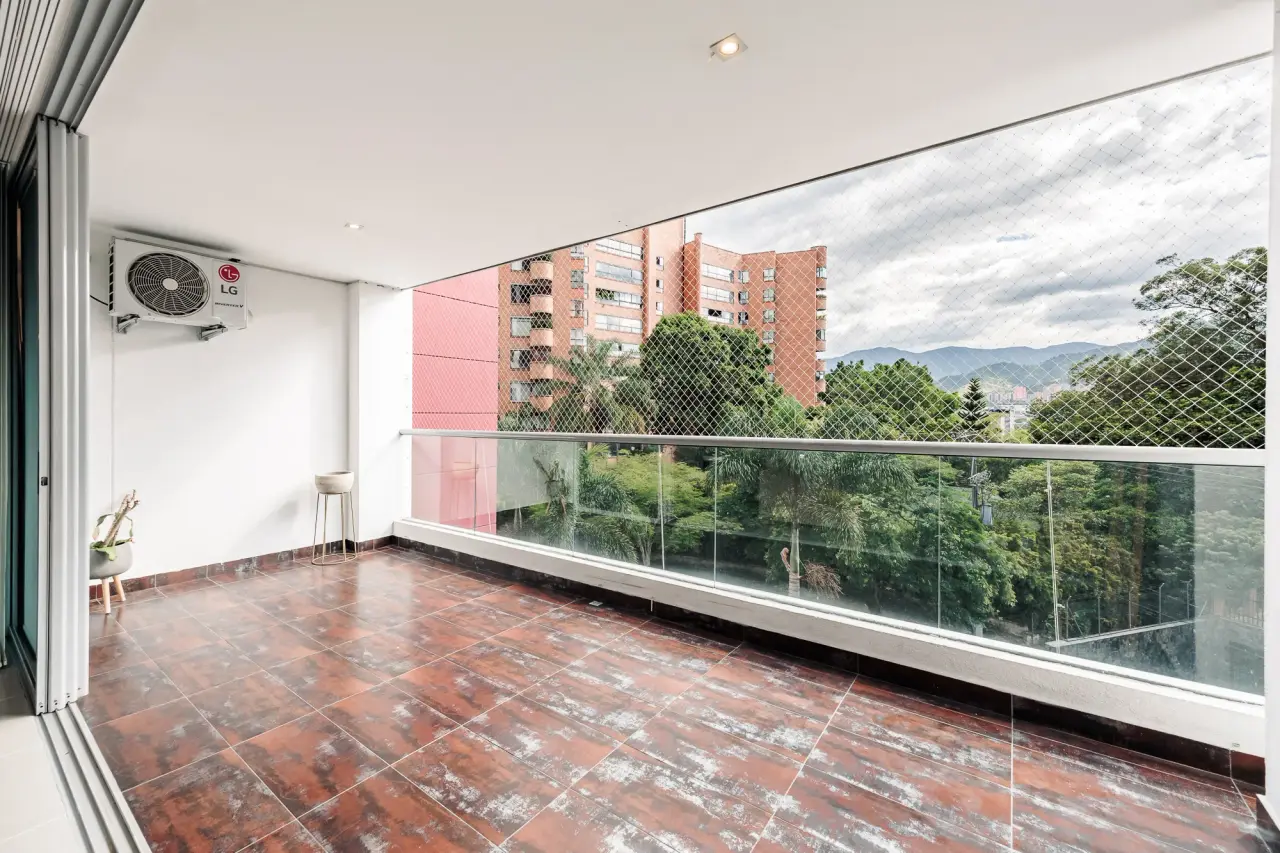 The full length of the tiled balcony with the glass doors folded right back at Balcón Verde