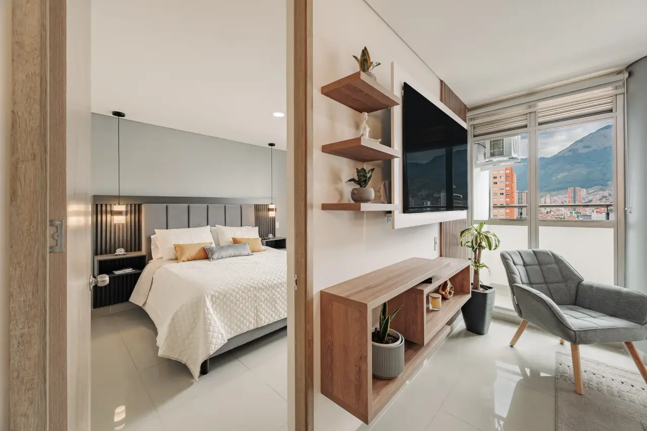 Bedroom with a desk and a city view, behind the sliding oak panel at Casa Roble