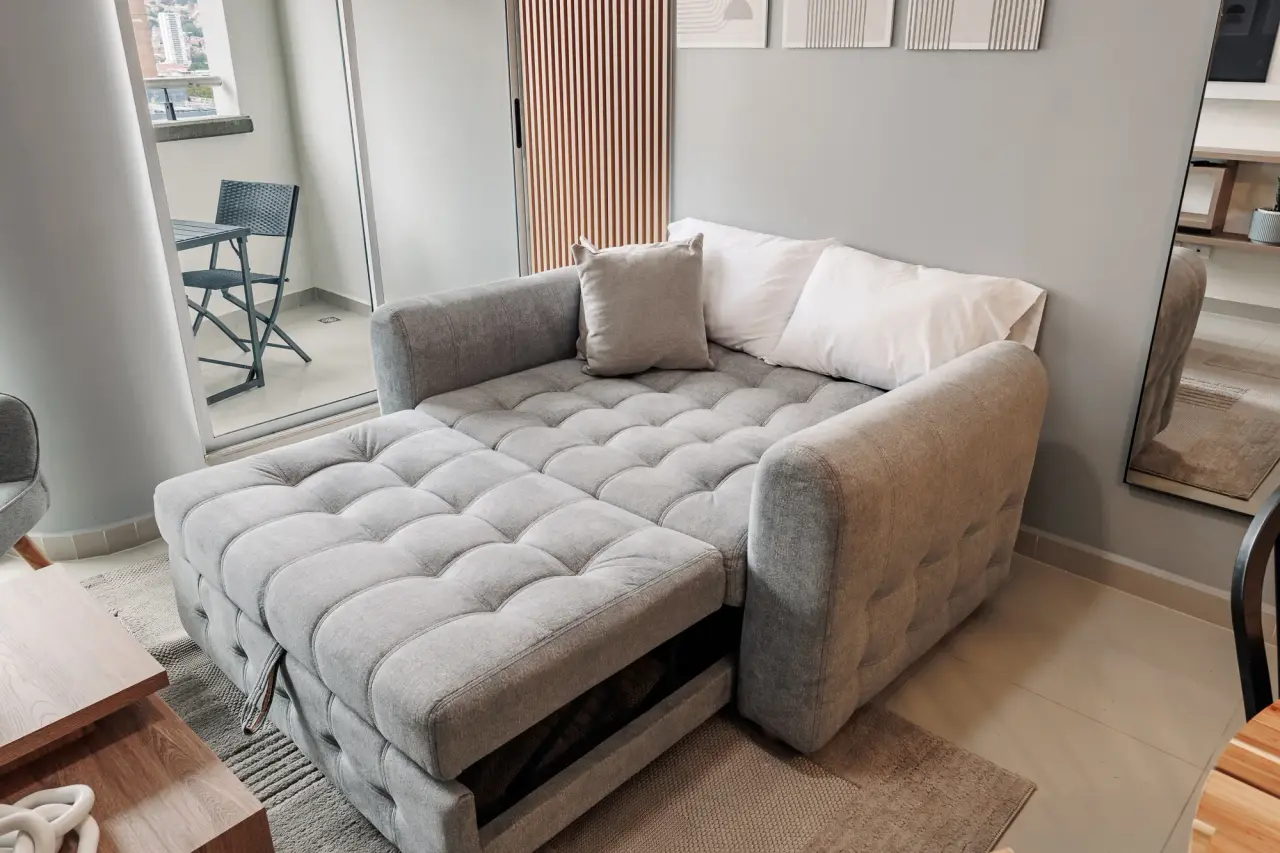 Deep sofa in the living room, with the desk by the window at Casa Roble