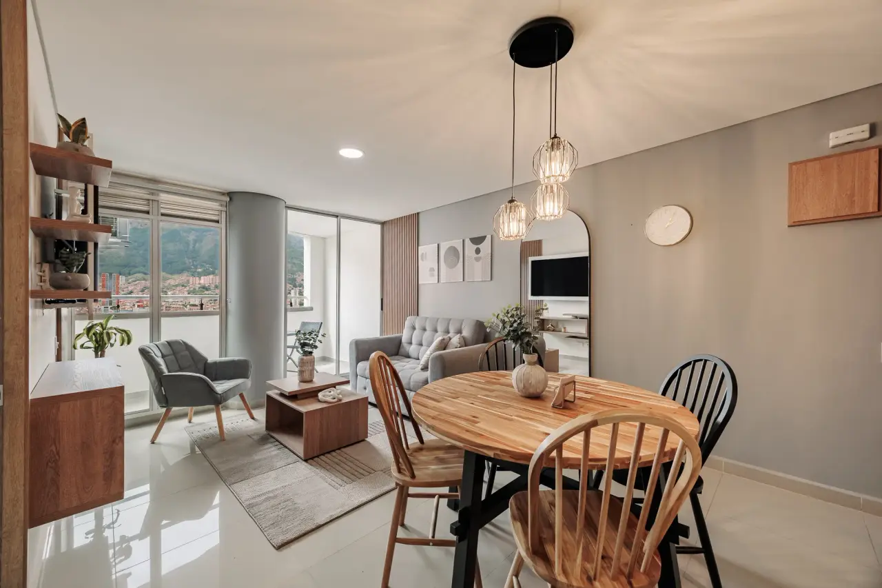 Dining table for four beside the kitchen, in the daylight from the balcony