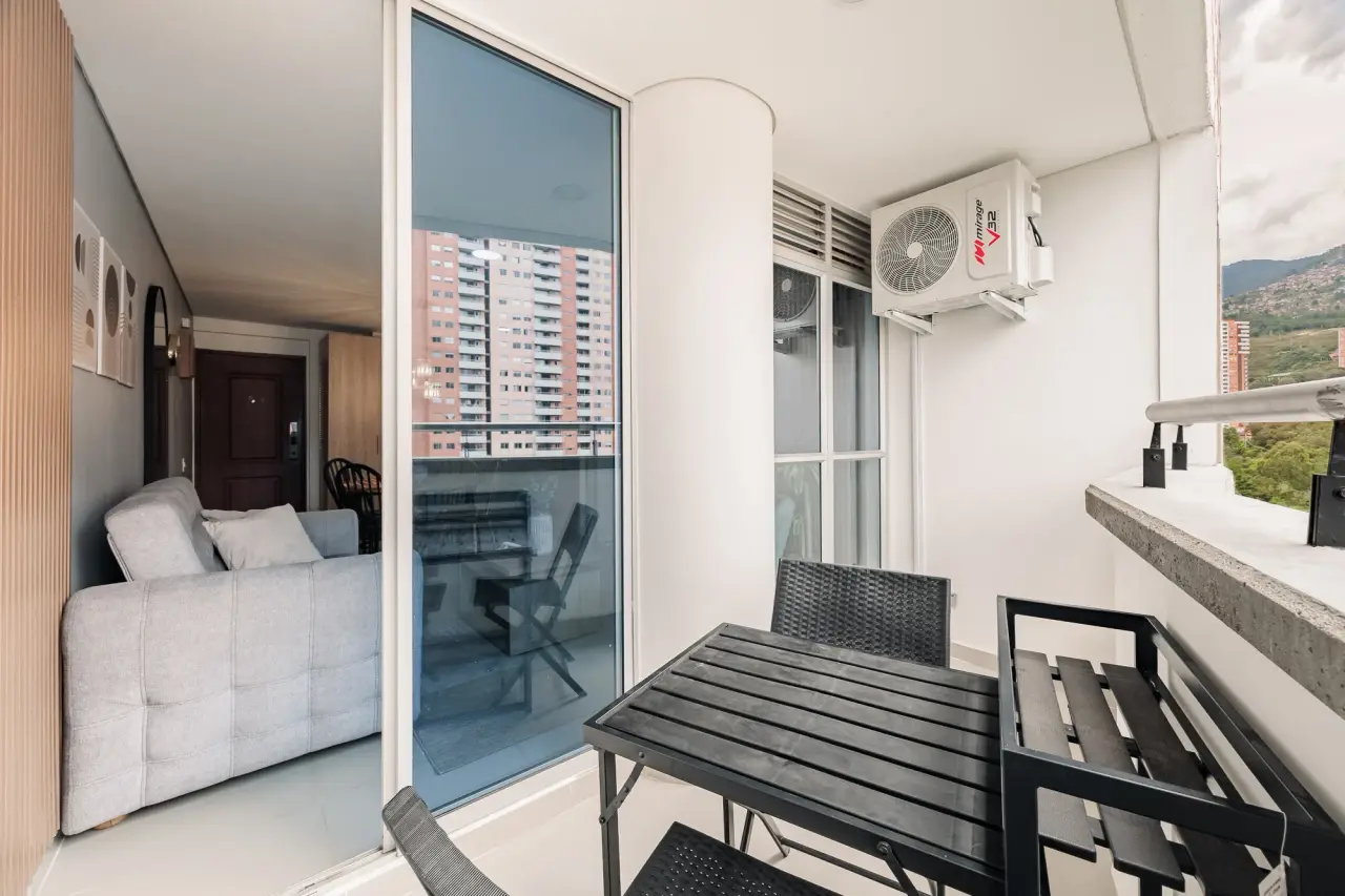 Bedroom with the balcony door open to the mountain view
