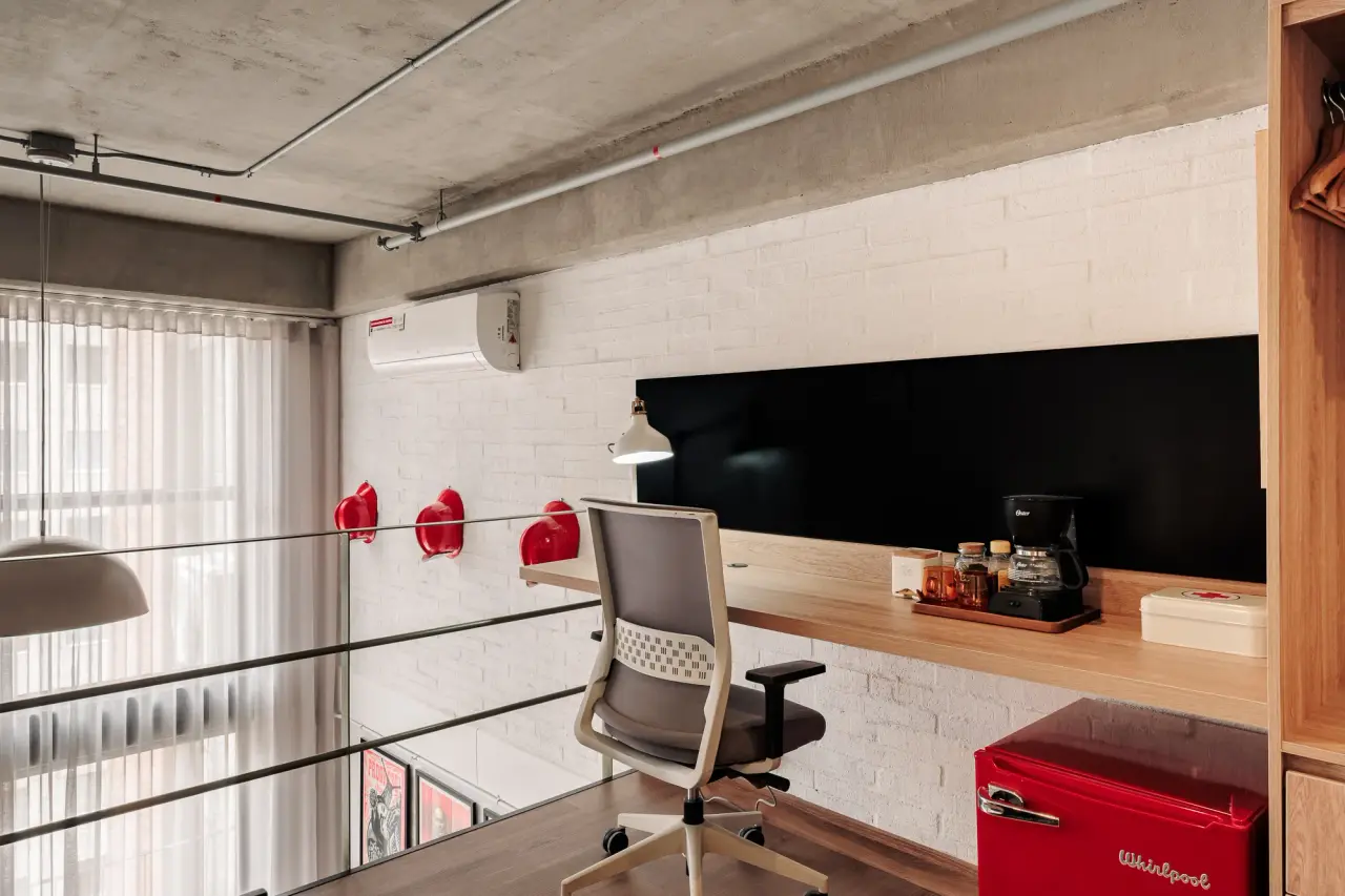 The desk on the mezzanine, tucked under the ceiling beside the bedroom