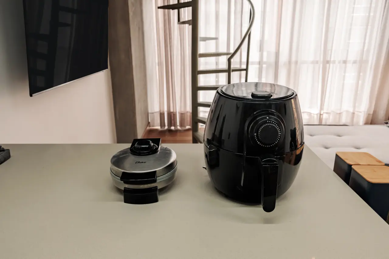 Air fryer and waffle iron on the kitchen counter