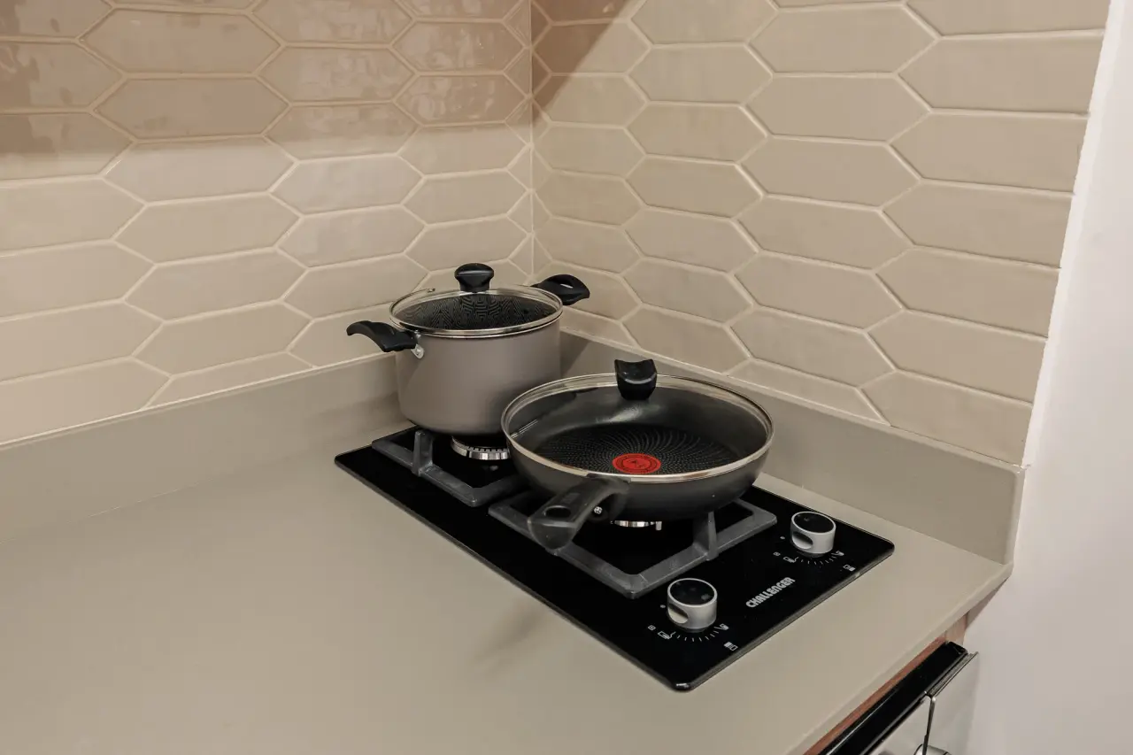 Gas cooktop with a pan, in the fully equipped kitchen
