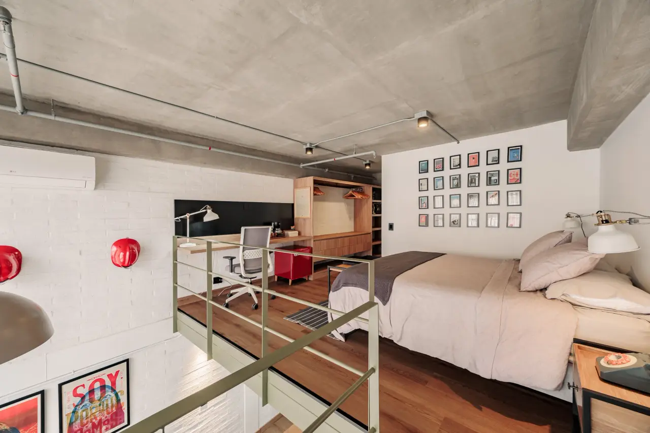 The mezzanine bedroom from the top of the stair, gallery wall behind the bed