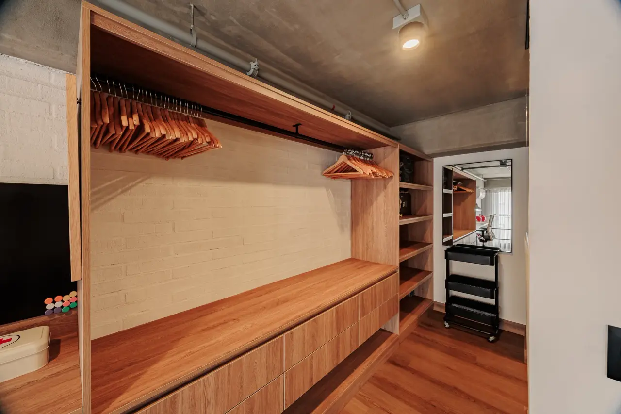 Walk-in wardrobe with a hanging rail, drawers and open shelving