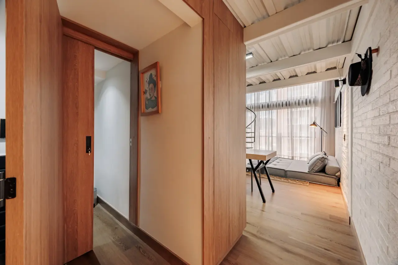 Timber door opening onto the living room at Centro Loft