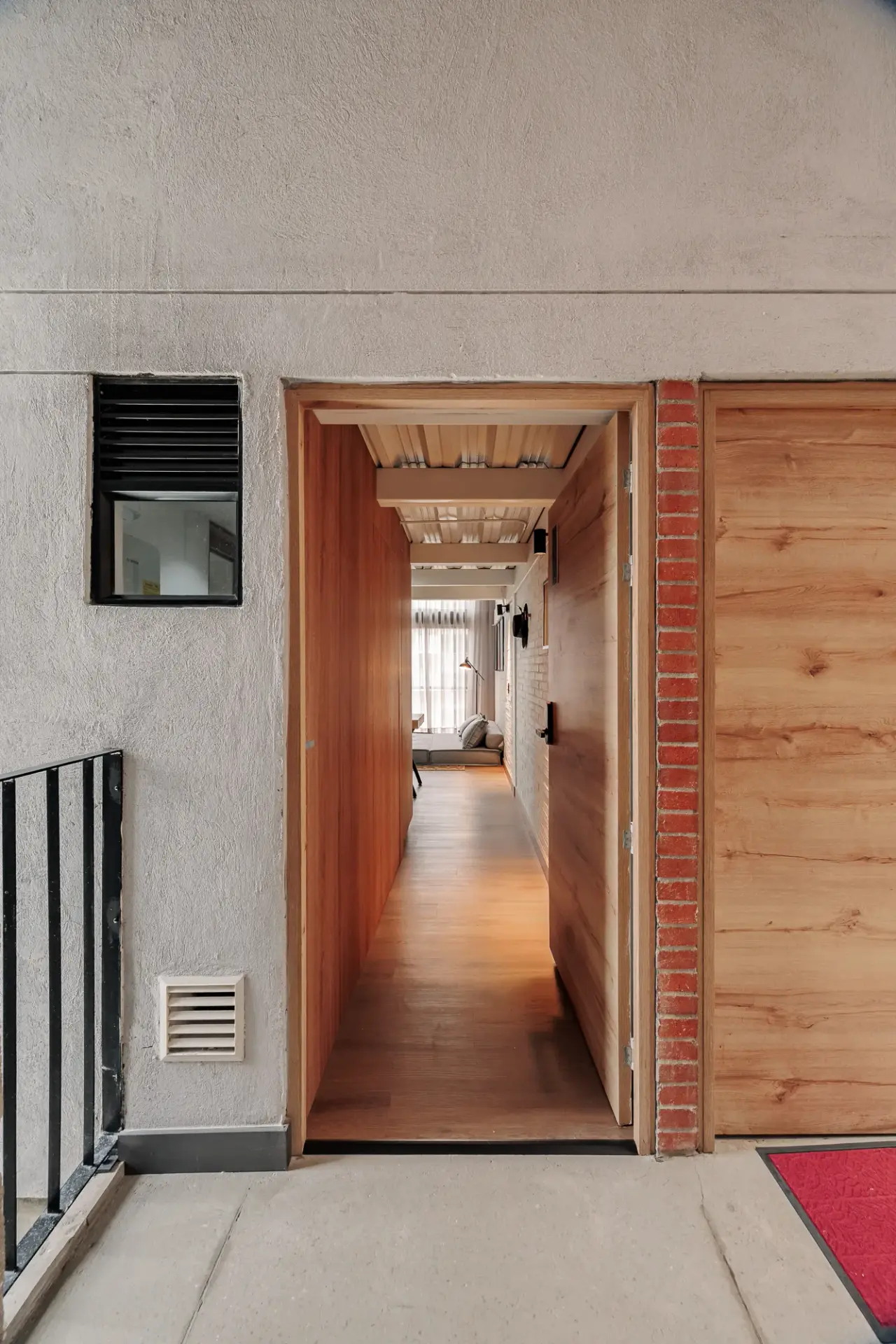 Entrance hallway, with brick on one side and timber on the other
