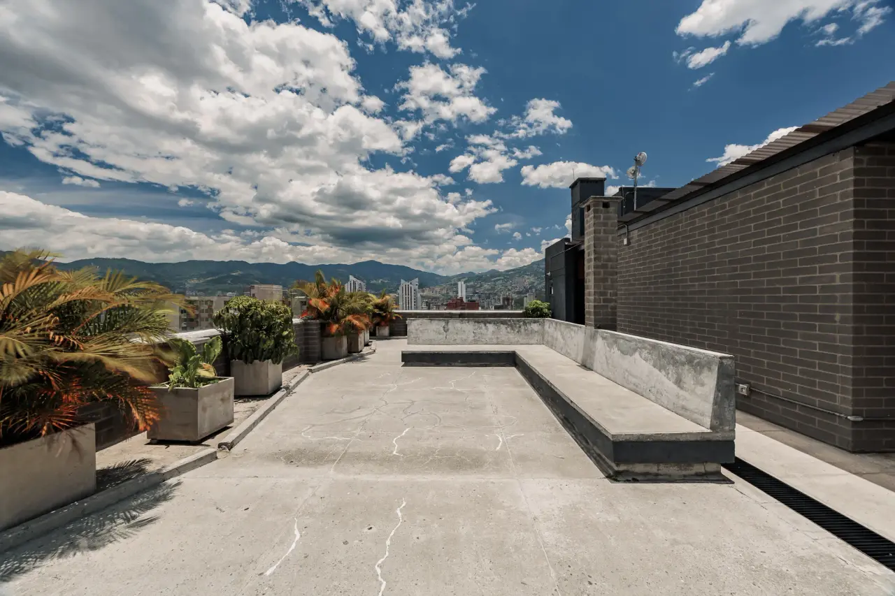 The building’s rooftop terrace, with planters and the city beyond